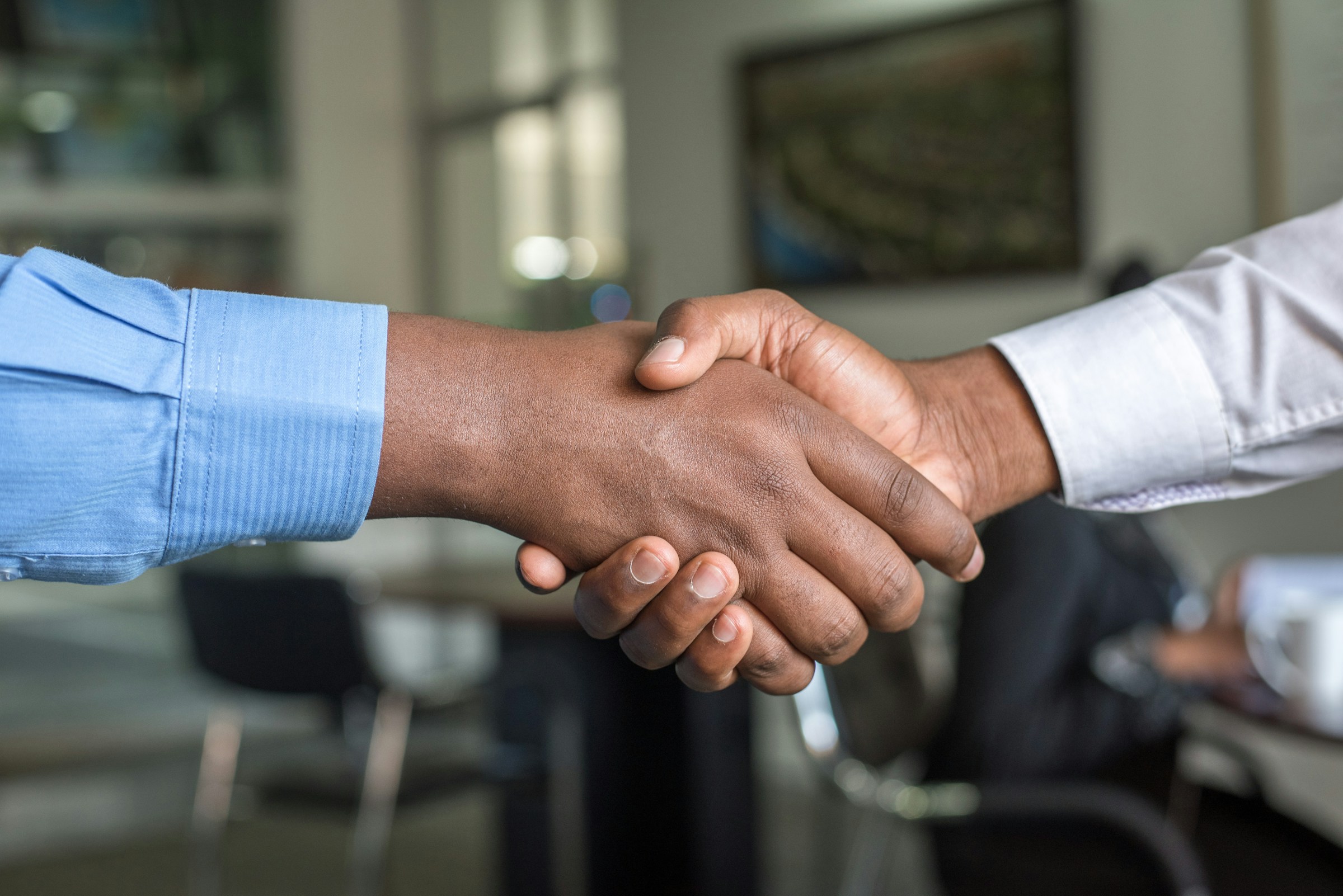 Handshake across the desk after a planning meeting