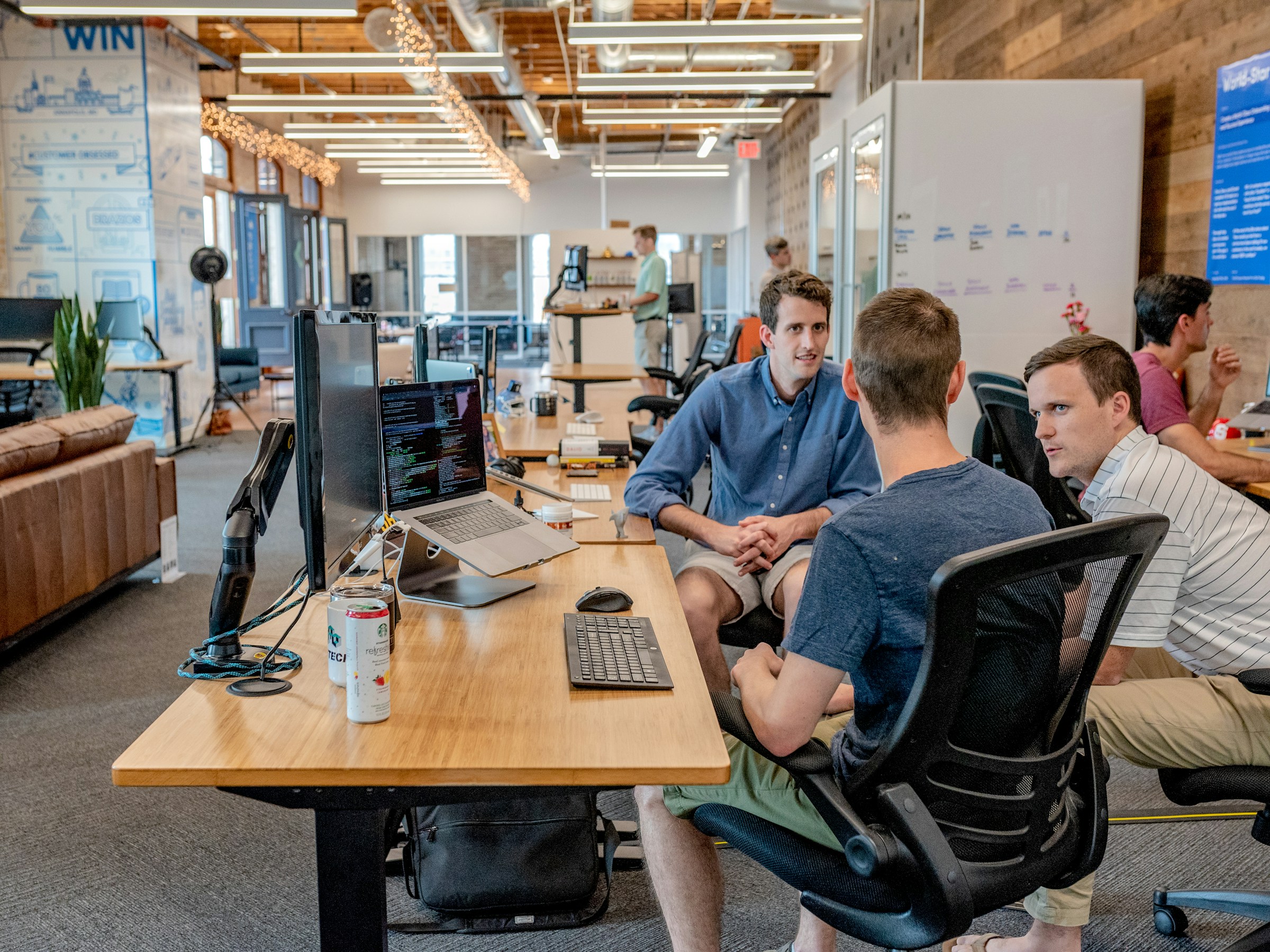 Team collaborating over a laptop in a bright office