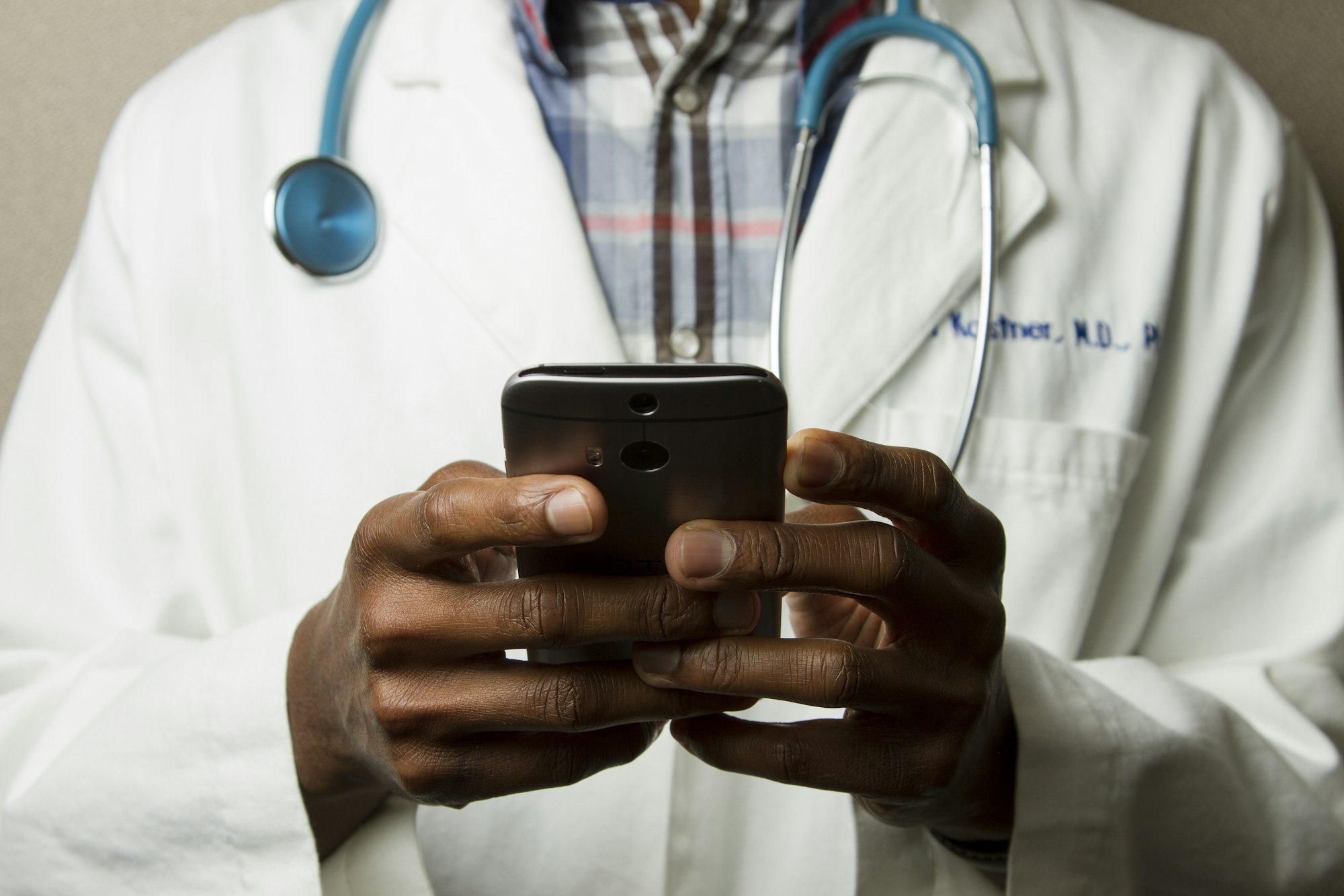 Healthcare professional reviewing records on a tablet