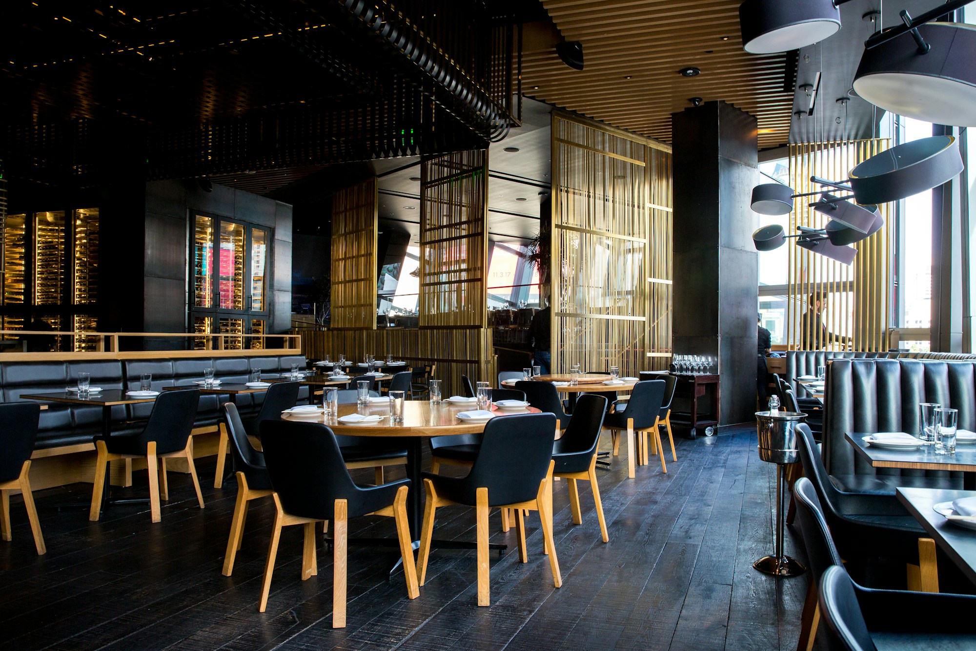 Warmly lit restaurant dining room set for service